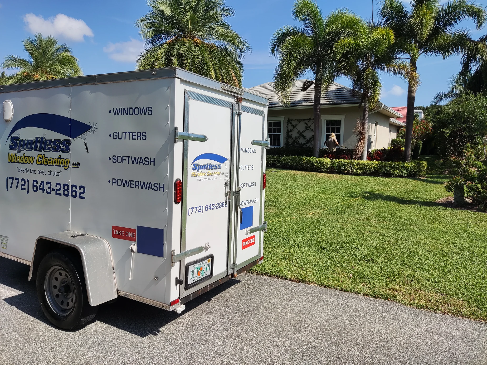 Spotless Window Cleaning LLC professional roof cleaning service removing black streaks and algae from a residential roof